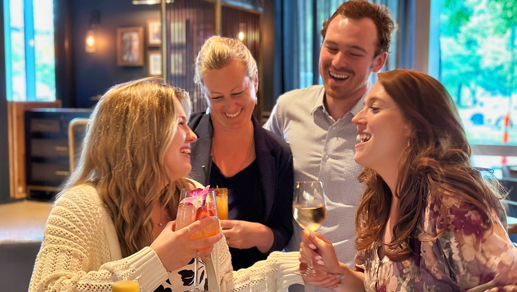 group of people enjoying drinks at the bar